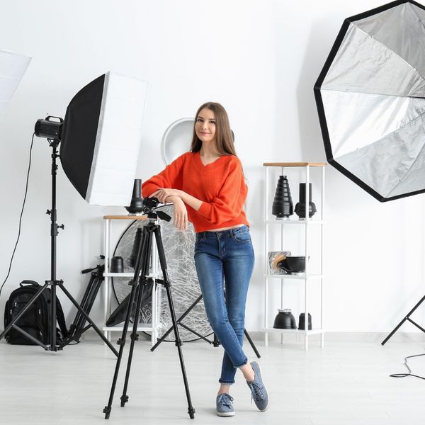 photographer surrounding by equipment at her studio