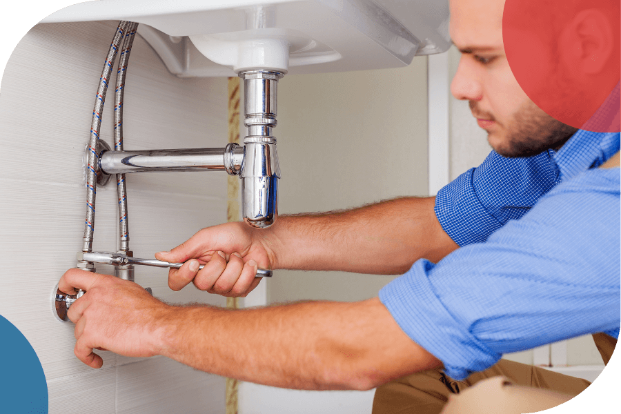 plumber working under sink