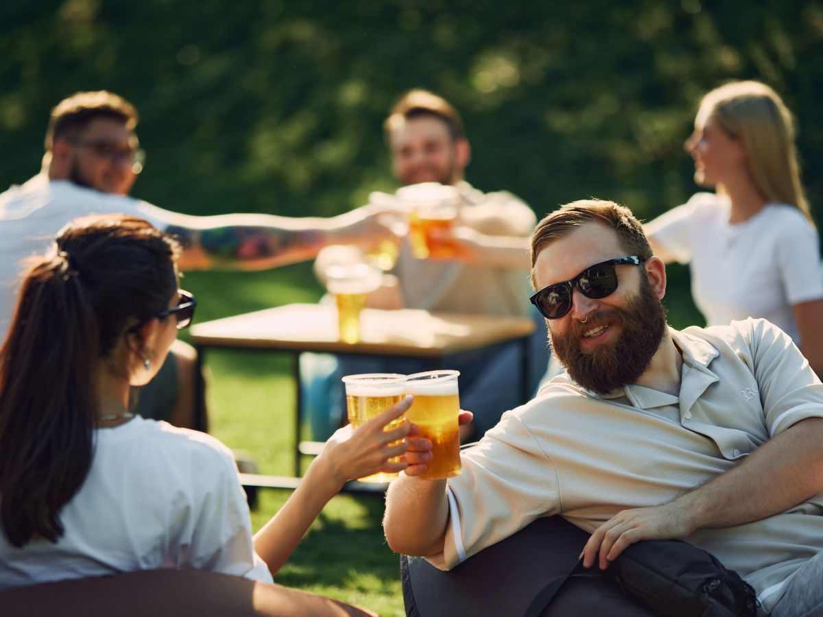 friends drinking beers together outside friends drinking beers together outside