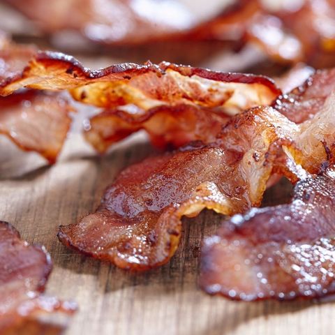 strips of bacon on a wood board