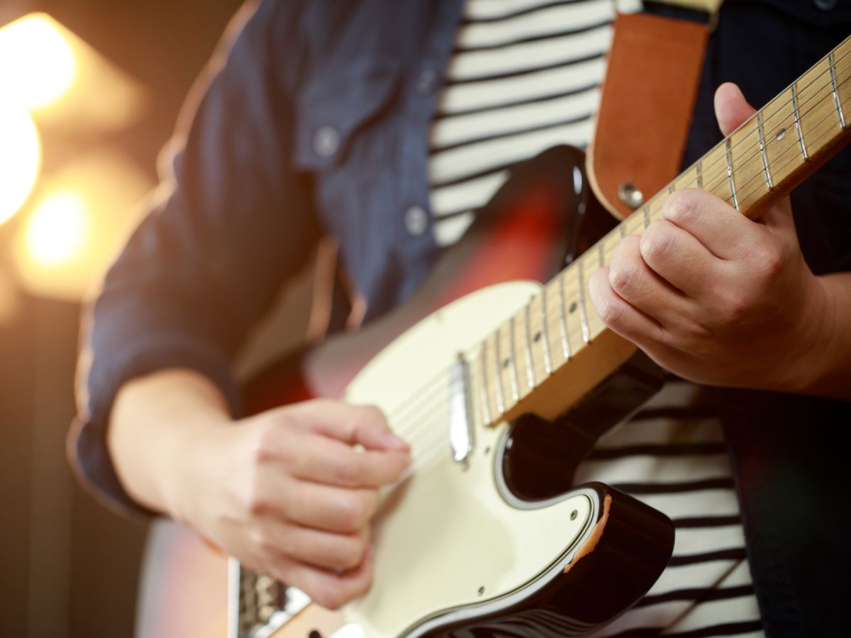 man playing electric guitar man playing electric guitar