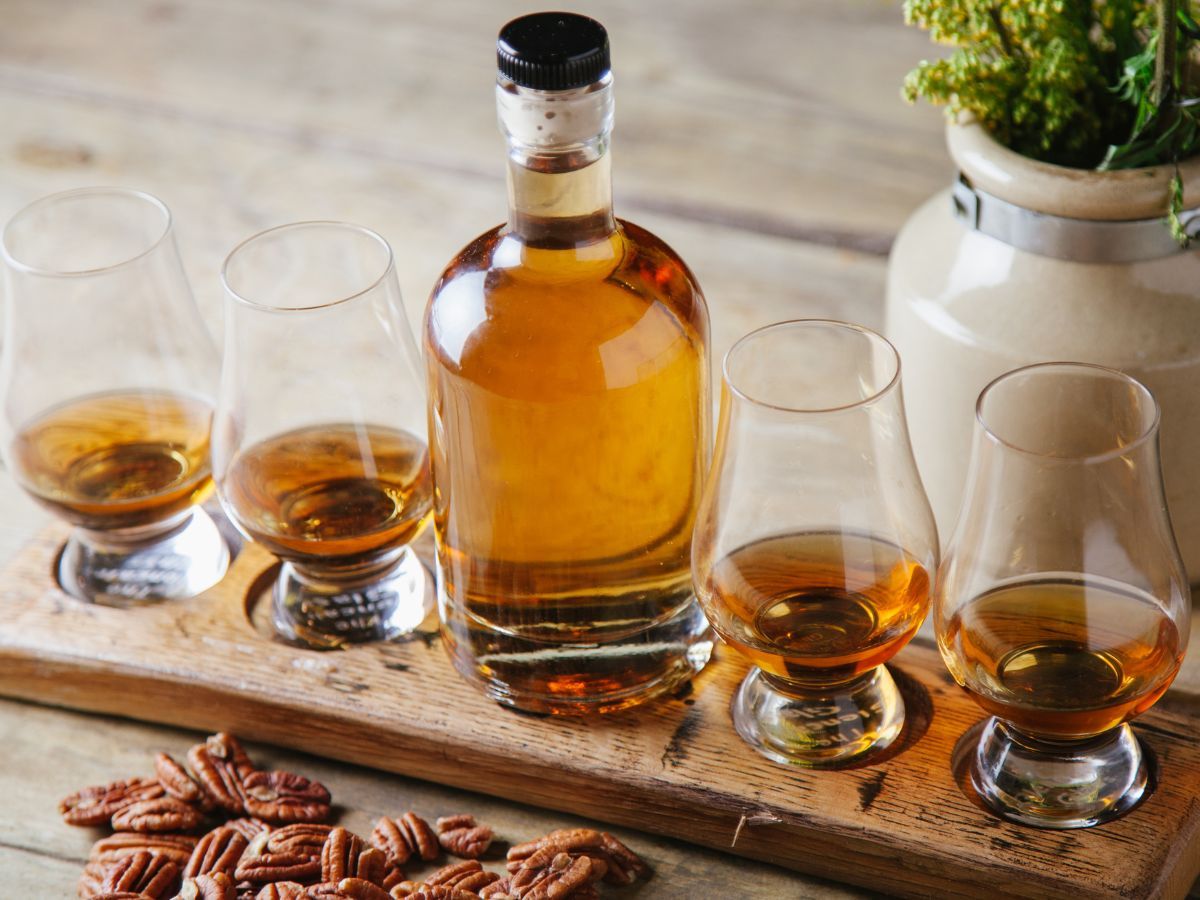 bottle of bourbon with tasting glasses poured