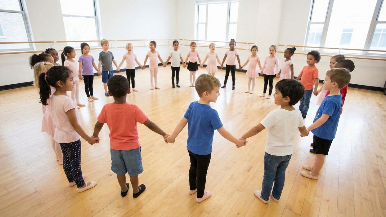 group of young children holding hands in a dance circle
