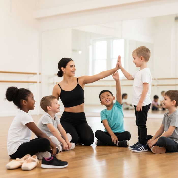 dancers smiling and one high-fiving their instructor