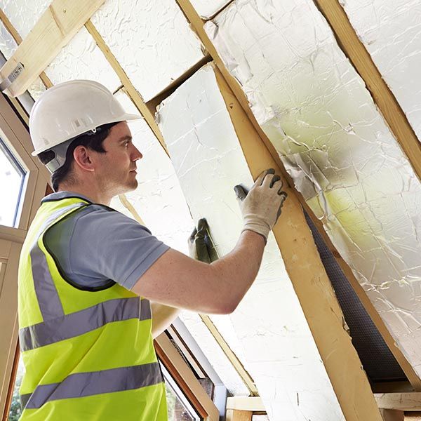 contractor installing insulation