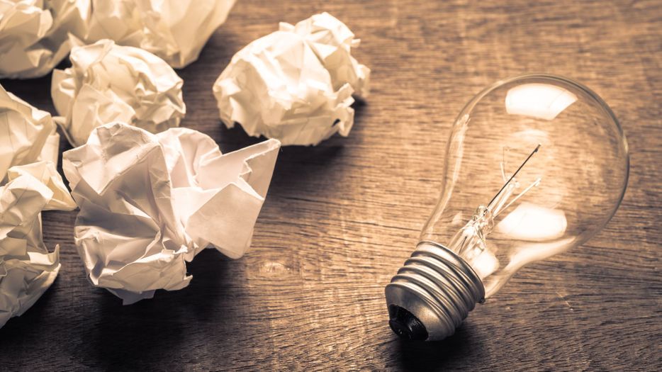 wadded up paper and a lightbulb