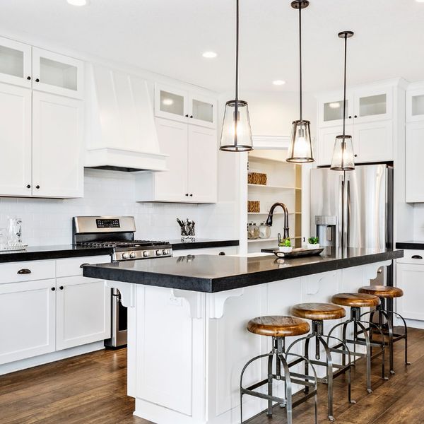 Image of a beautiful kitchen with black countertops.