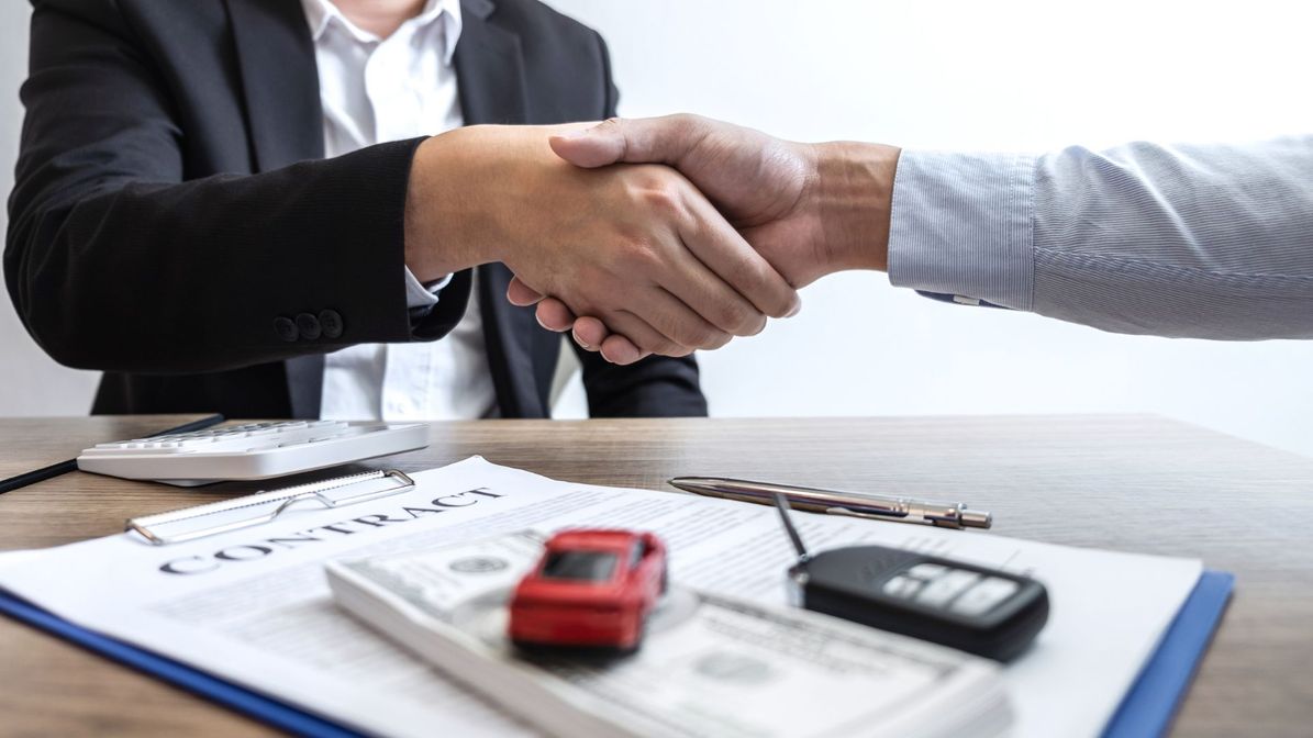Insurance agent and client shaking hands