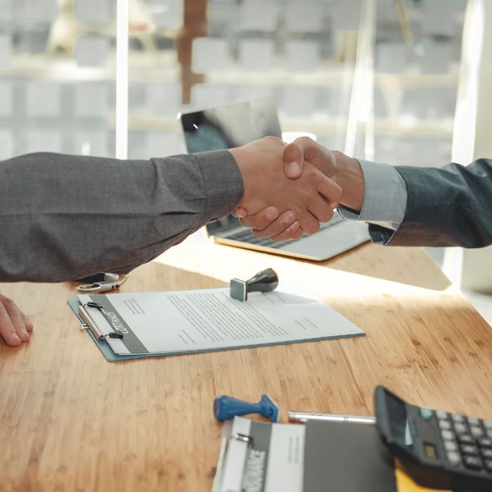 insurance agent and client shaking hands