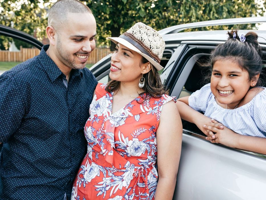 happy family with vehicle on a nice day