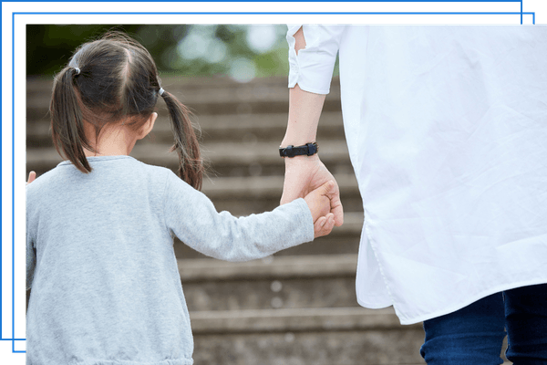 child holding parents' hand