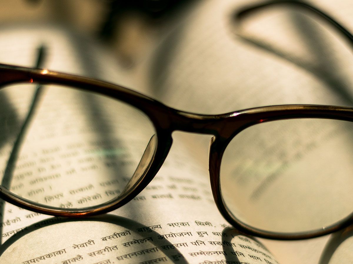 pair of reading glasses on a book