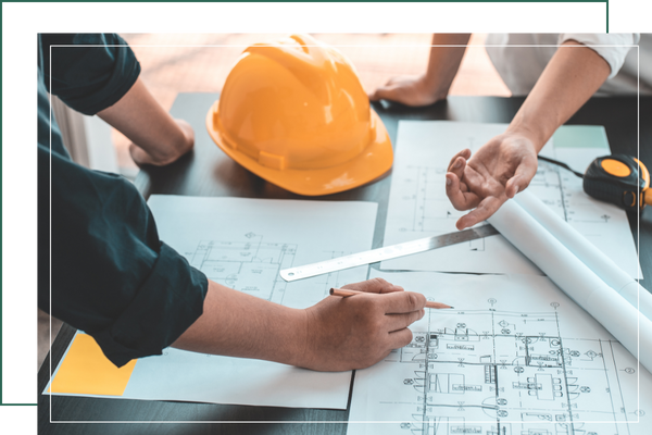 team working together on blueprints for custom build