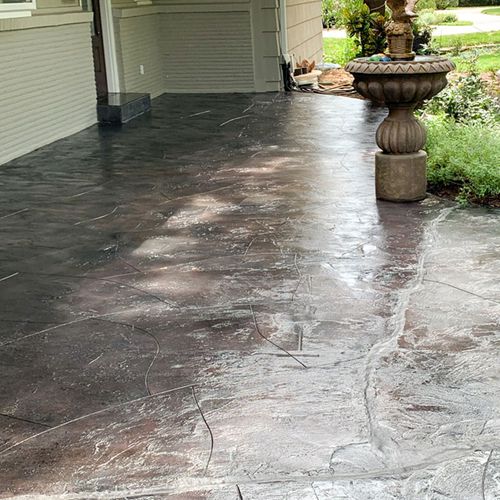 a concrete patio with a fountain