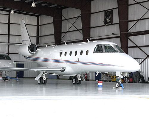 a white airplane in a hangar