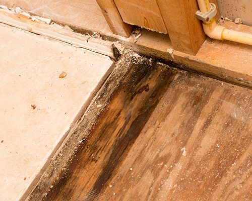 a wood floor with a yellow pipe