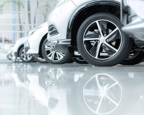 a row of cars parked in a showroom