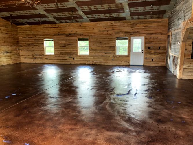 a room with a wood wall and windows