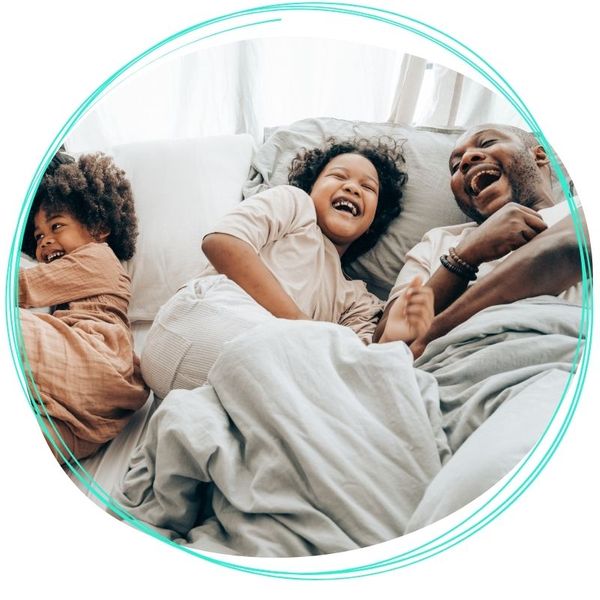 family laughing in bed family laughing in bed
