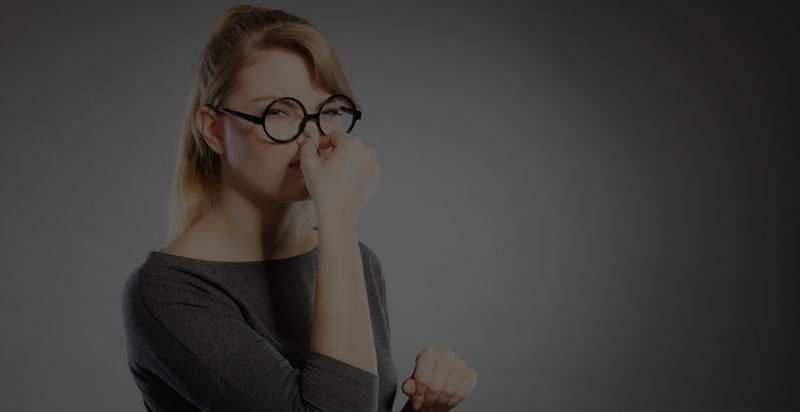 Woman holding her nose