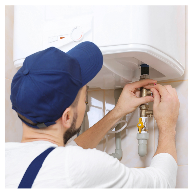 A plumber fixing a water tank