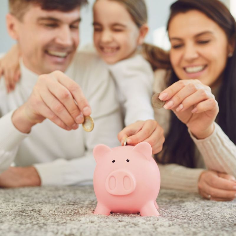 Family saving money in a piggy bank