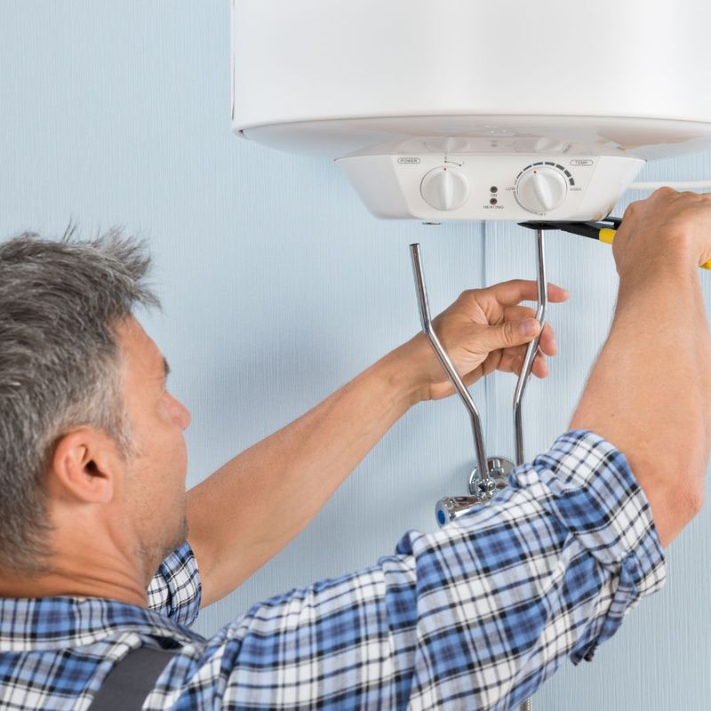 man installing water heater