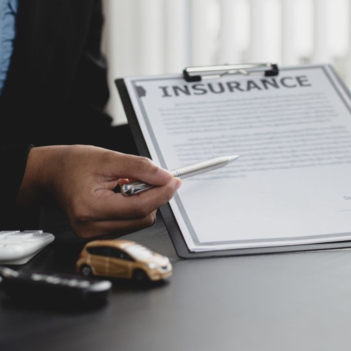agent pointing to insurance paperwork
