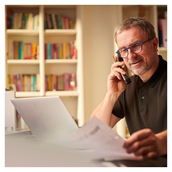 business owner on the phone looking over documents