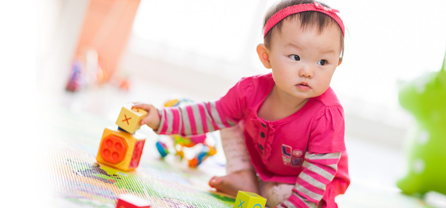 toddler playing with colorful blocks