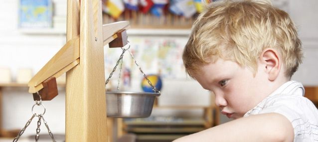 child playing with a scale