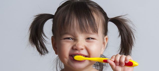 toddler brushing her teeth