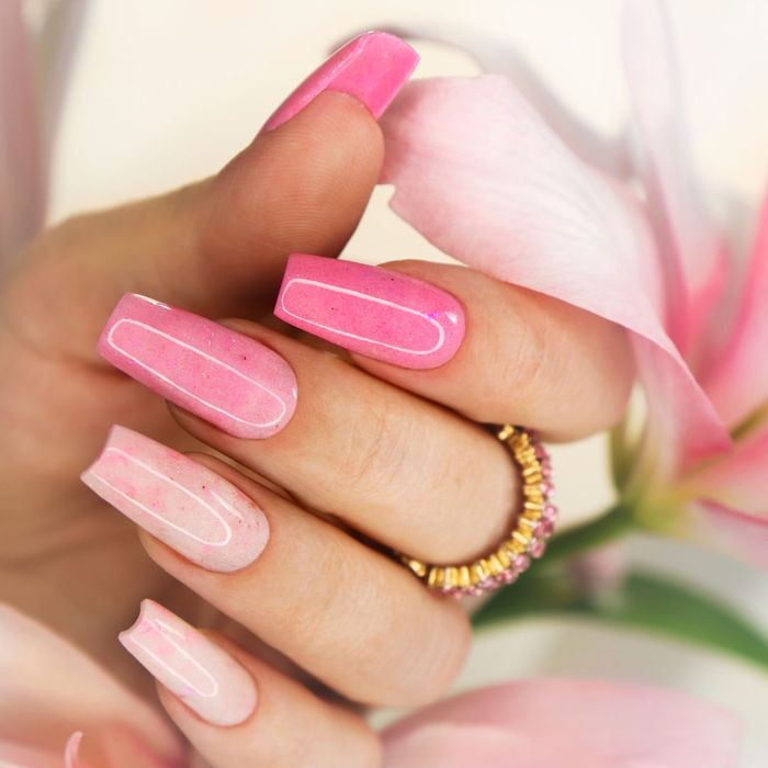 pink nails next to a flower