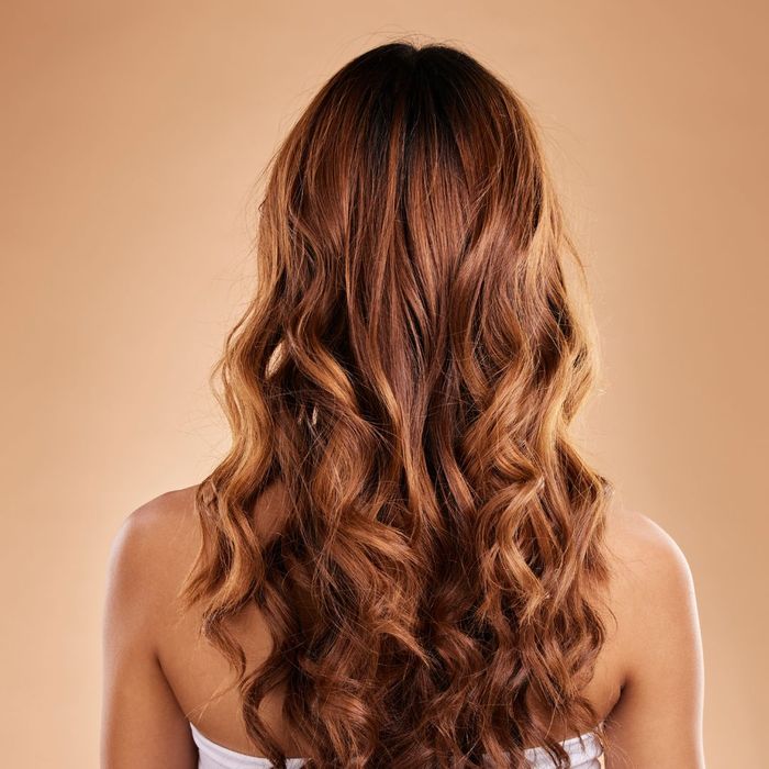 woman with light brown hair extensions in her brown hair
