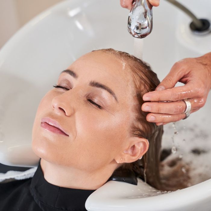 Woman getting her hair shampooed and washed at a salon. 