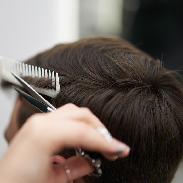 man getting a hair cut.