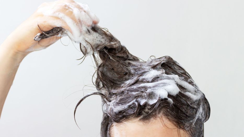 woman holding up soapy hair