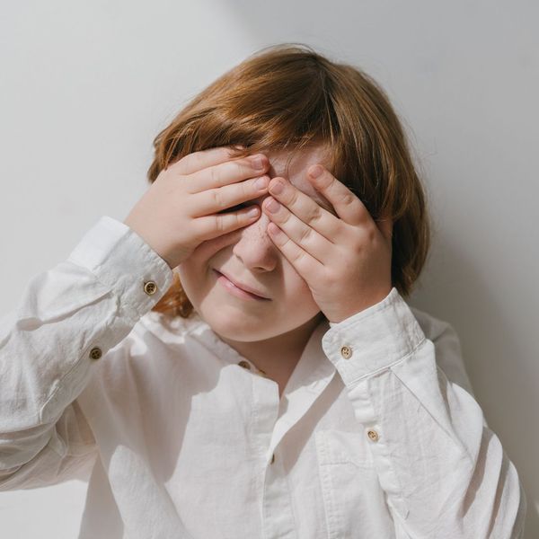 Child covering his eyes. Child covering his eyes.