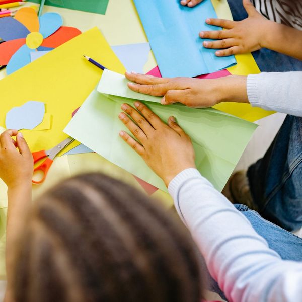 Kids cutting out shapes in paper. Kids cutting out shapes in paper.