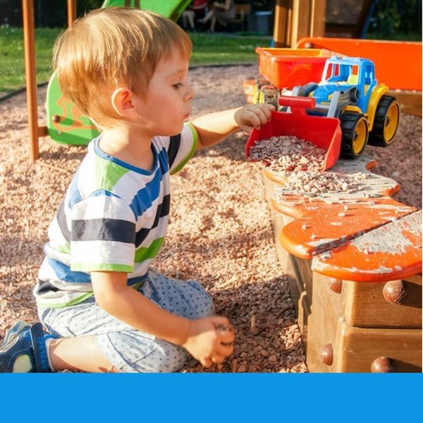 little boy playing with dump truck in sand little boy playing with dump truck in sand