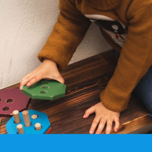 child playing with wood toy child playing with wood toy