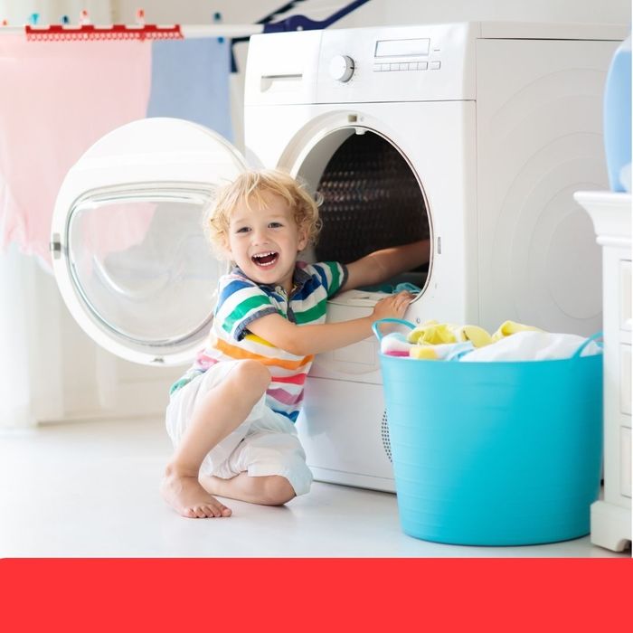 a child pulling clothes out of a dryer In-Home Services (2).jpg