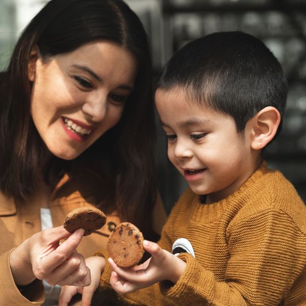 child with mom eating a cookie