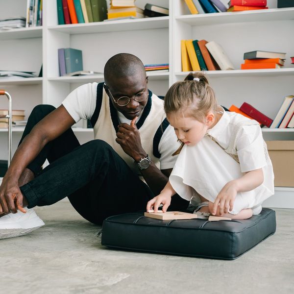 man working with little girl at therapy