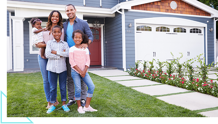 family in front of new home