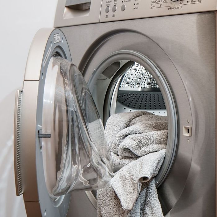 An open dryer with a towel