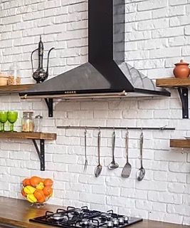 Black cooktop and hood vent in kitchen