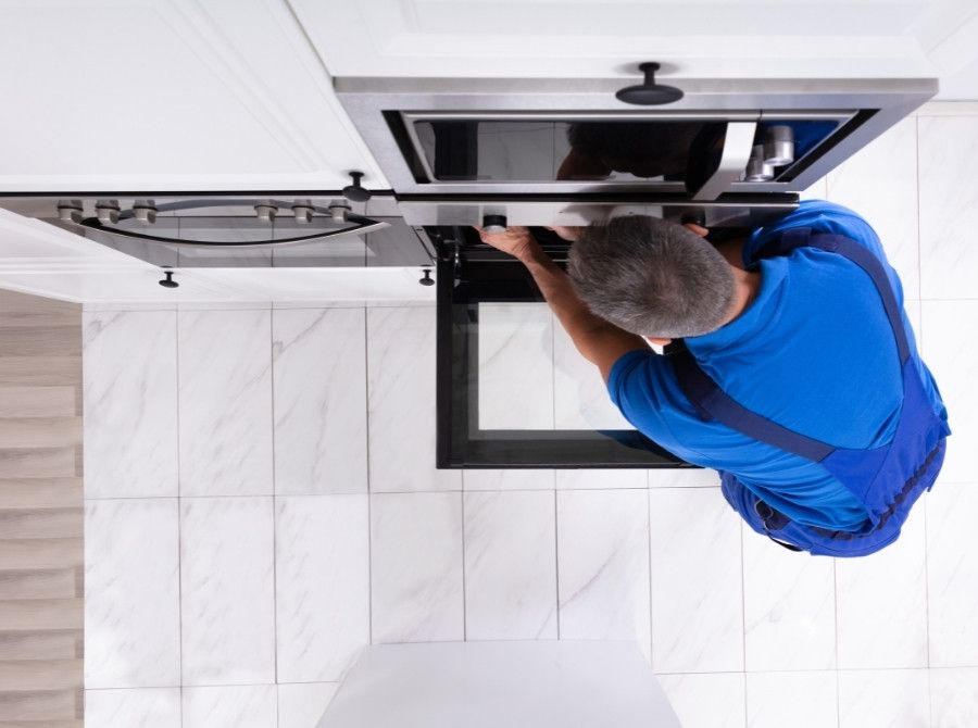 technician repairing oven