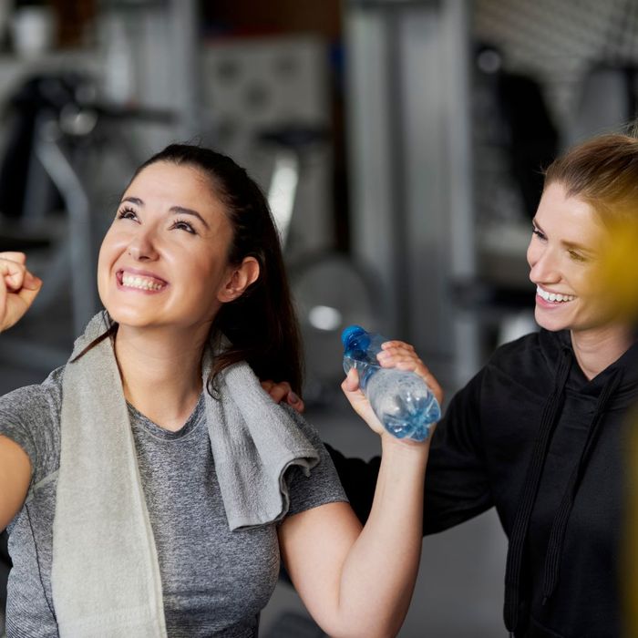 two women smiling at gym