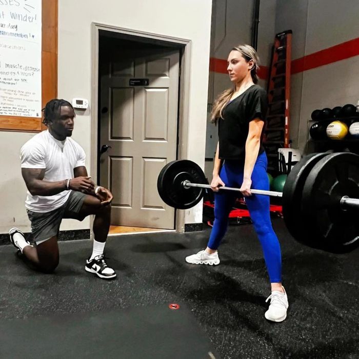 fitness coach working with female client